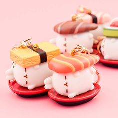 three small sushi cat figurines sitting on top of each other