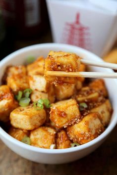 tofu with chopsticks in a white bowl