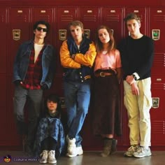 a group of young people standing next to each other in front of lockers with their arms crossed