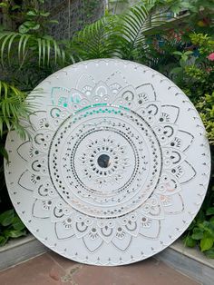 a large white plate sitting on top of a sidewalk