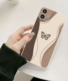 a woman's hand holding an iphone case with a butterfly on it