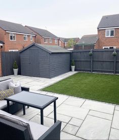 a backyard with lawn and patio furniture