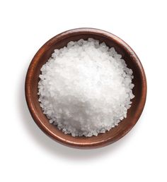 a bowl filled with white sugar on top of a table