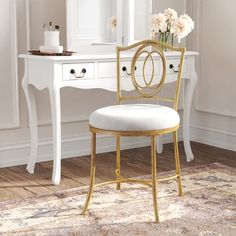 a white desk with a mirror, chair and flowers on it in front of a window