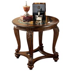 a wooden table with a glass top and some books sitting on it's side