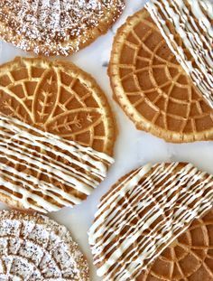 several different kinds of cookies with icing on them