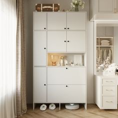 a white cabinet with drawers and shelves in a living room next to a window that has sheer drapes on the windowsill