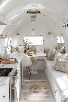 the interior of an airstream is clean and ready to be used as a dining area