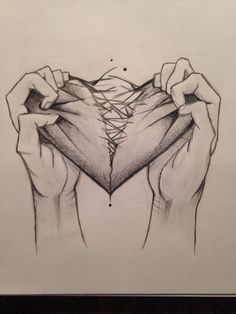 two hands holding up a piece of paper with the shape of a heart in it