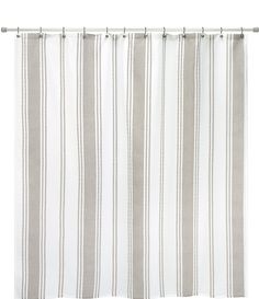 a white and grey striped shower curtain hanging from a metal rod on an isolated background