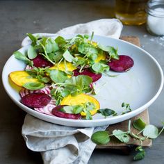 a white plate topped with beets and greens