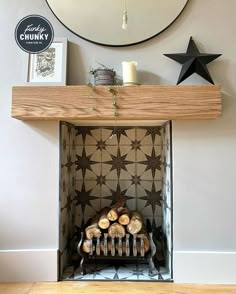 This image is part of a transformation and shows a zoomed-in shot of a gorgeous chunky mantel, on top of the mantel there are some photos and decorations and below there is a log burner. Chunky Furniture, Take Good Pictures, Oak Mantel, Real Wood Furniture, Wooden Mantel, Bedroom Fireplace