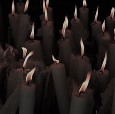 many lit candles with white and orange flames