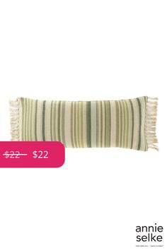 a striped pillow with fringes on it and the price tag for $ 222