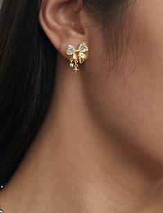 Materials: 18k gold plated brass, cubic zirconia Measurements: 18mm/0.7" in width, 23mm/1" in length Cute Girly Earrings, Gold Glamorous Jewelry With Bow, Glamorous Gold Jewelry With Bow, Formal Gold Plated Bow Jewelry, Gold Plated Bow Jewelry For Party, Cute Gold Earrings, En Route Jewelry, Dope Jewelry, Bow Jewelry