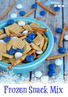 frozen snack mix in a blue bowl with marshmallows and pretzels