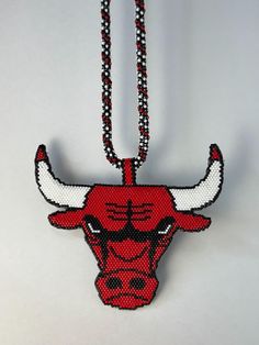 the chicago bulls'logo is made out of bead and hangs on a chain