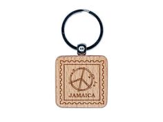 a wooden keychain with the word jamaica on it and a peace sign in the middle