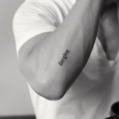 a man with a small tattoo on his arm