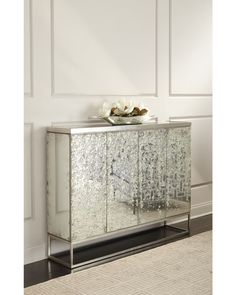 a mirrored cabinet in a room with white walls