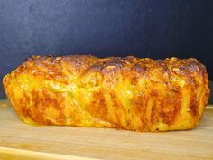 a piece of bread sitting on top of a wooden cutting board