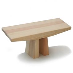 a wooden bench sitting on top of a white floor