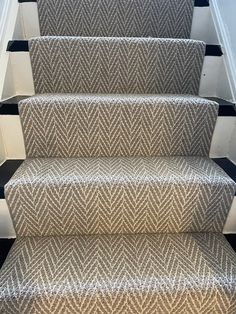 a carpeted staircase with black and white stripes