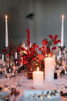 the table is set with candles and place settings