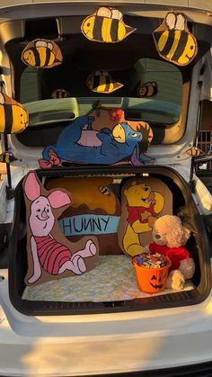 the trunk of a car with winnie the pooh decorations