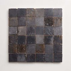 a piece of slate tile that looks like it has been cut into squares and placed on the wall