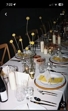 the table is set with place settings for dinner