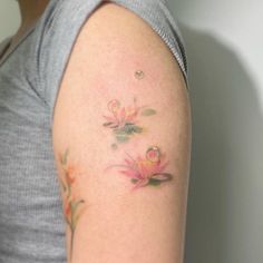 a woman with a flower tattoo on her arm