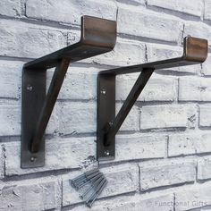 two metal brackets mounted to a brick wall