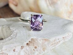 This classic solitaire setting contains a beautiful 2.00ct natural Rose De France amethyst. The antique cushion cut stone measures approximately 9x7mm and the band is 2mm wide. The ring is available in sterling silver, and 14k white, yellow, or rose gold. This ring makes a unique promise or engagement ring. Please send me a message if you need a size not listed. * This ring can be customized with any color center stone. All items are handmade by me in my shop in Woodbridge, NJ. Please message me Luxury Lavender Amethyst Ring With Prong Setting, Classic Lavender Amethyst Ring With Prong Setting, Purple Amethyst Ring With Rectangular Stone, Lavender Amethyst Solitaire Ring As A Gift, Lavender Amethyst Solitaire Ring For Gift, Lavender Emerald Cut Amethyst Ring, Lavender Emerald-cut Amethyst Ring, Lavender Engagement Ring, Divorce Ring