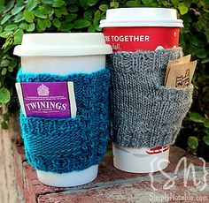 two knitted coffee cups sitting next to each other