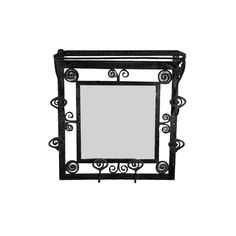 a mirror that is sitting on top of a shelf with wrought ironwork around it