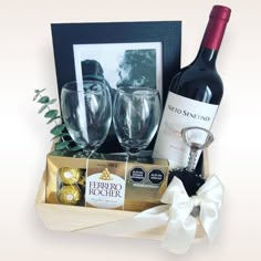 wine and chocolates in a wooden box with a bottle of wine