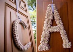 the letters are made out of flowers on the door and hanging from the front door