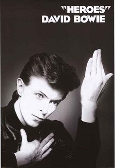 a black and white photo of a man with his hands up