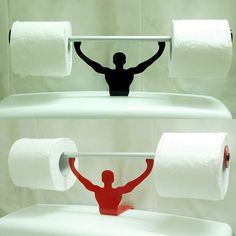 a toilet with two rolls of toilet paper on it and a man standing next to them