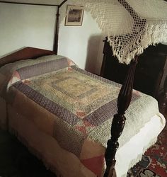 an old fashioned bed in a bedroom with a canopy