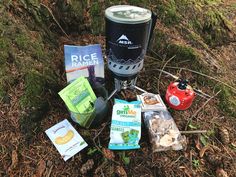 an assortment of food and drink items sitting on the ground