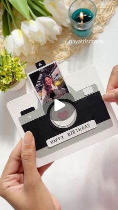 someone is holding up a card with an image on it and the words happy birthday