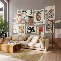 a living room filled with furniture and pictures on the wall