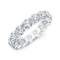 a white gold ring with round cut diamonds on the sides and four rows of stones in the middle