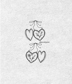 three hearts are drawn on paper with the words love written below them in cursive writing