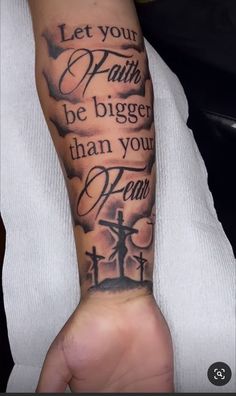 a person with a tattoo on their arm that says let your faith be bigger than your fear