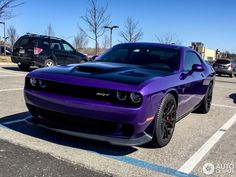 a purple and black car parked in a parking lot