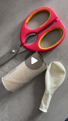 two pairs of scissors are sitting next to a roll of toilet paper and a knife