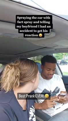 a man and woman sitting in the back seat of a car looking at their cell phones